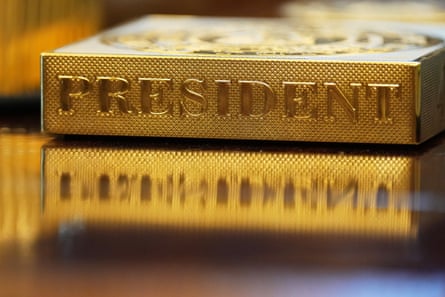 A gold item labelled ‘president on a desk